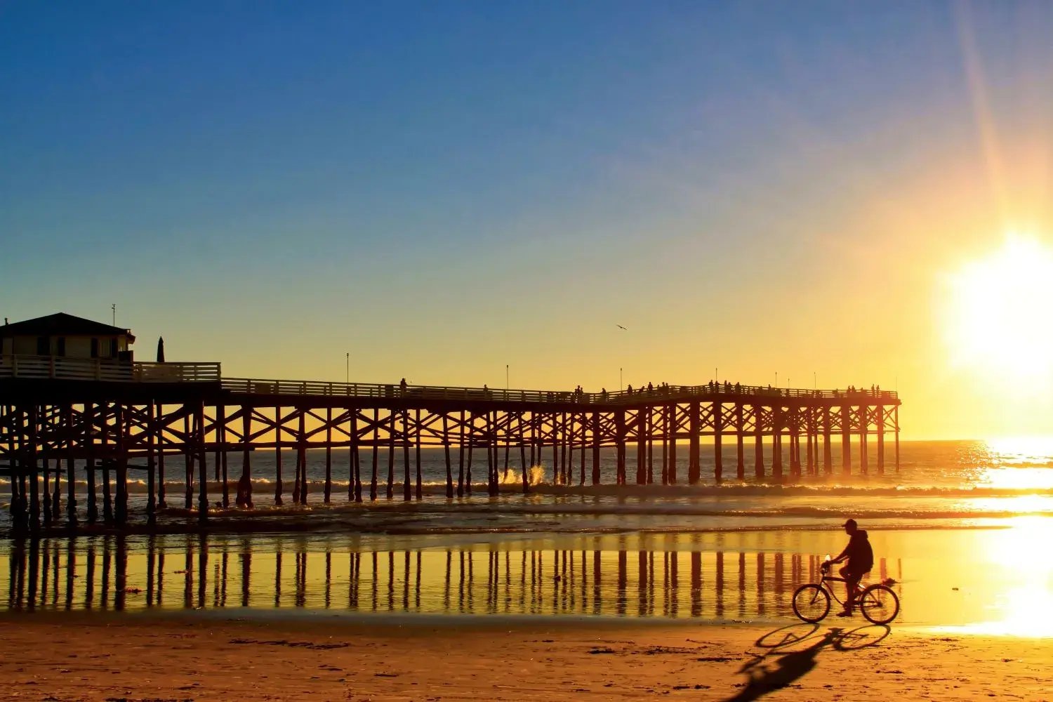 Cyclist on beach in San Diego