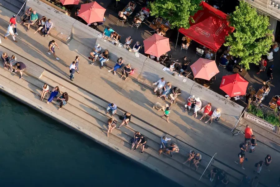 Bird's eye view of people sitting by a city canal
