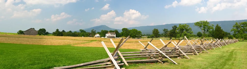 The Newmarket Battlefield, showing a grass field and wooden fences