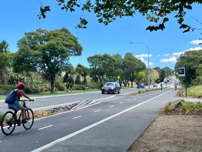 Cyclist riding on Meola Road in Auckland